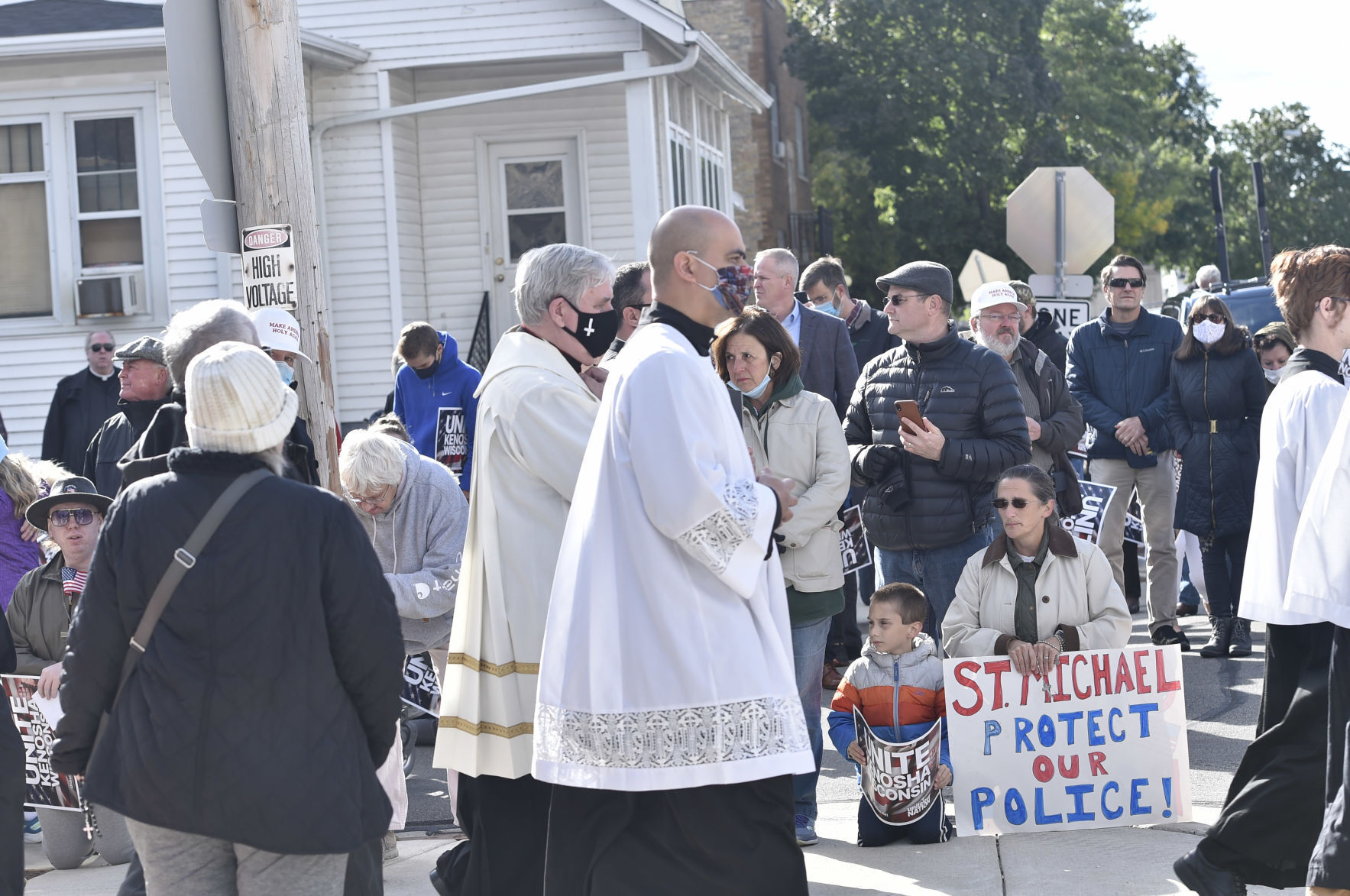 Listecki leads peaceful march as woman kneels and holds "St. Michael Protect Our Police" sign